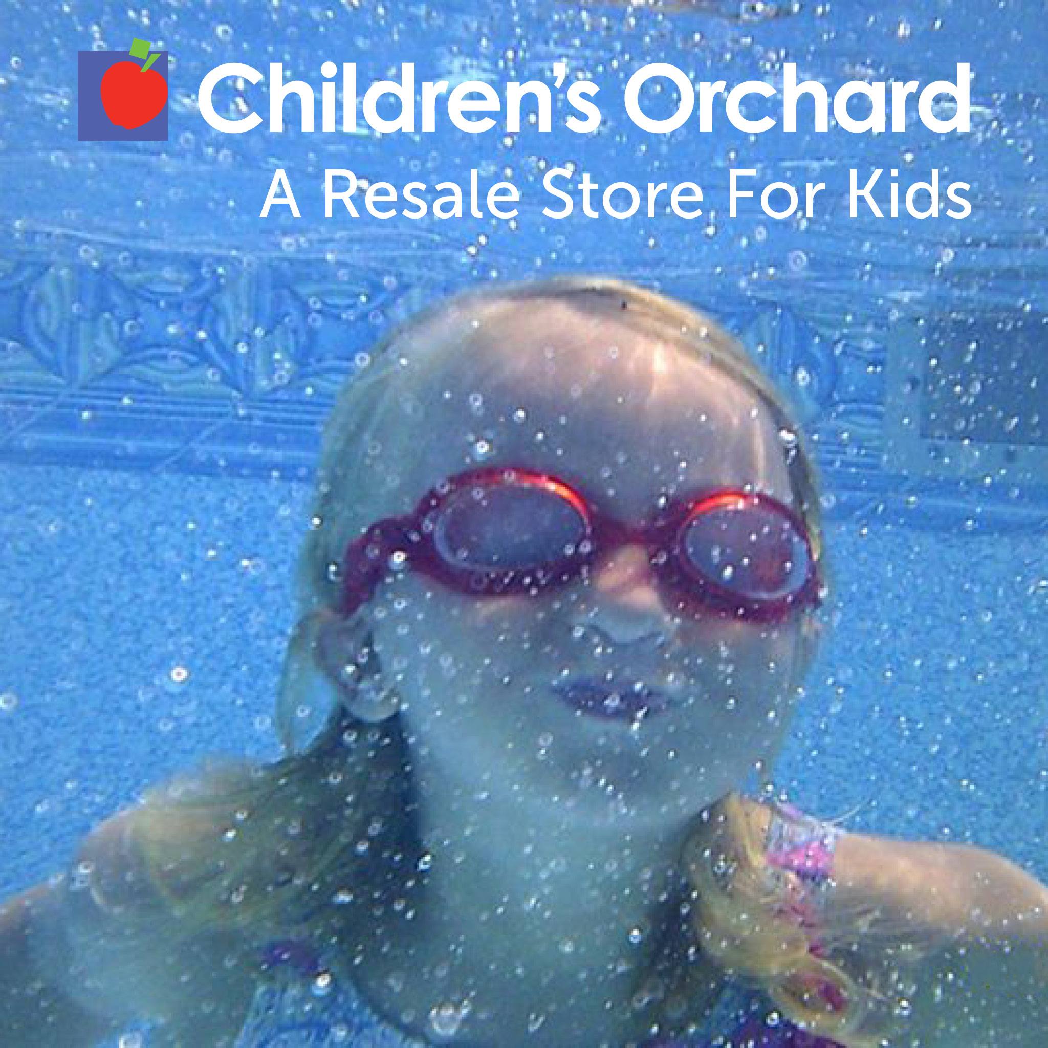 A resale store for kids. Little girl swimming underwater wearing goggles
