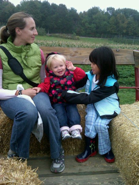 Children's Orchard two girls and mom on hay ride