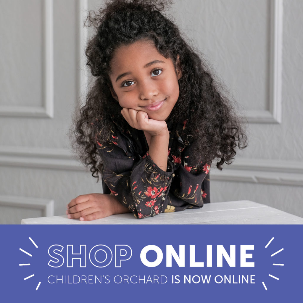 Shop online: Children's Orchard is now online. Little girl leaning on elbow wearing flower patterned shirt.