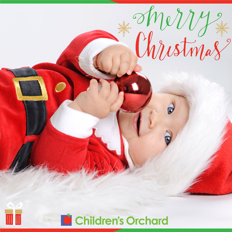 Children's Orchard baby wearing santa outfit and text that says merry christmas