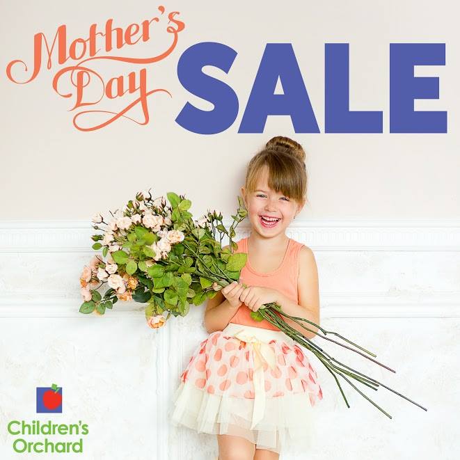 Mother's day sale. Girl in dress holding flowers.